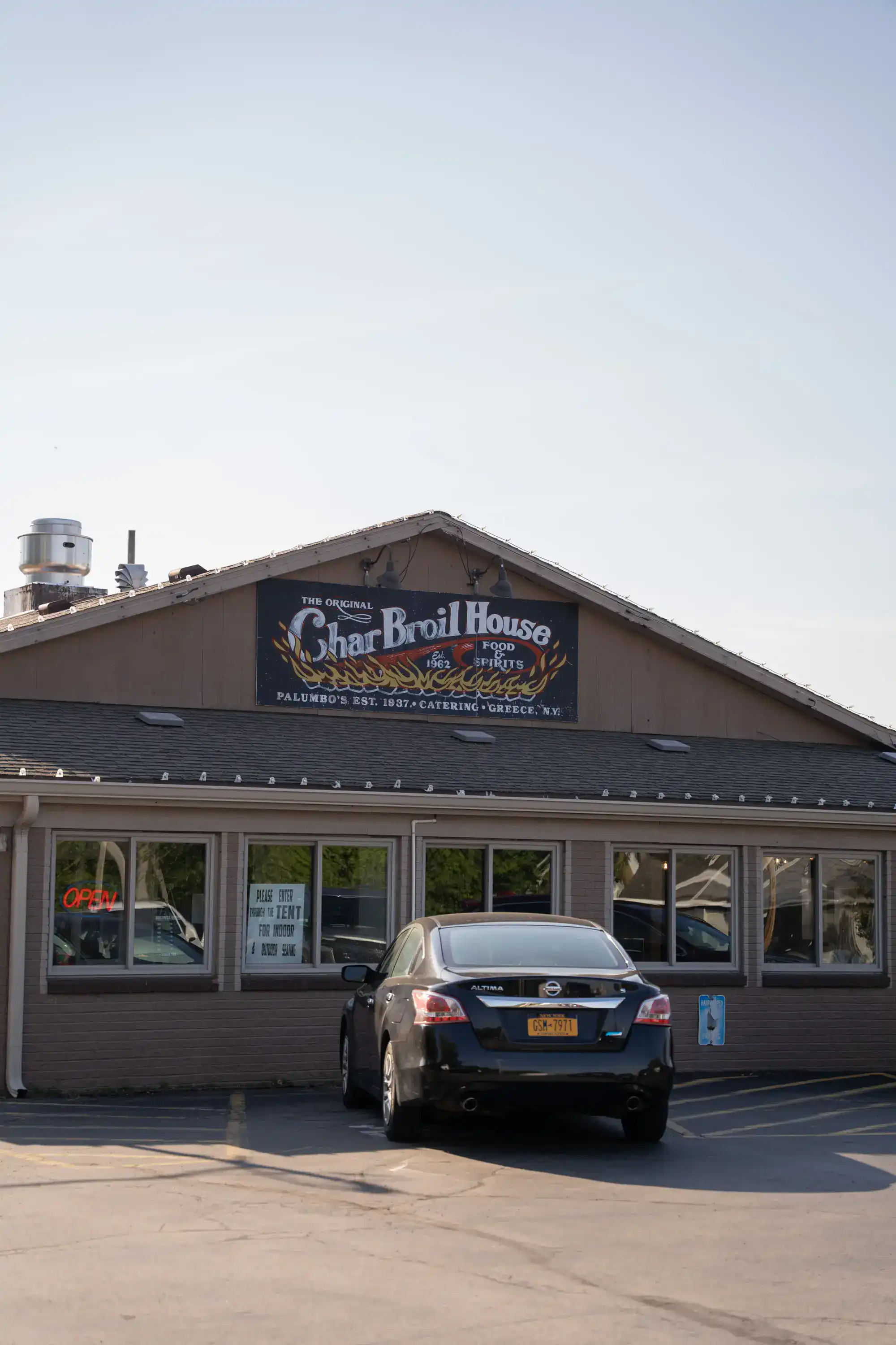 The Original Charbroil House restaurant exterior with sign and parking in Greece, NY